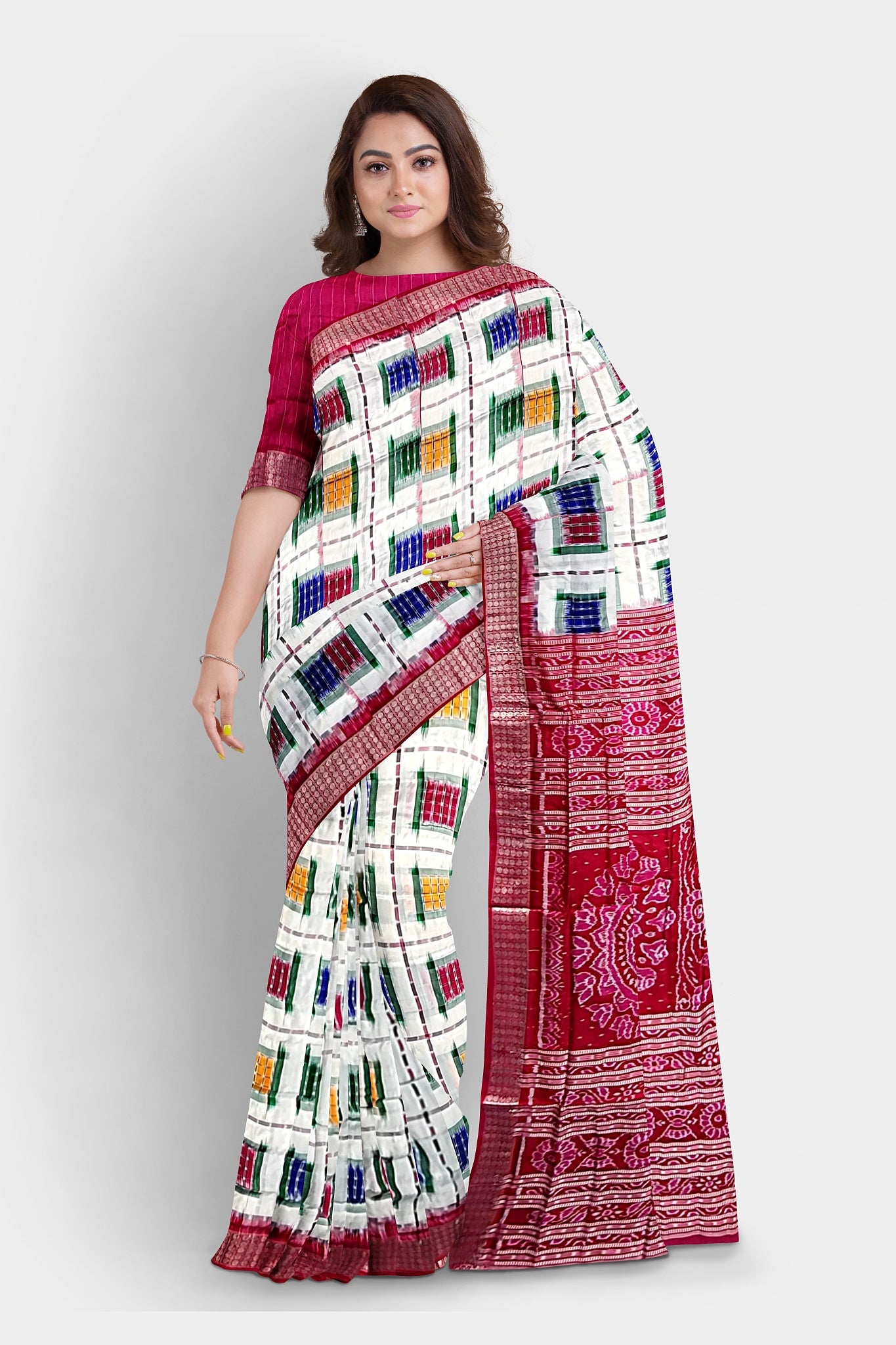 A stunning white and red saree featuring multicolor box patterns, a pallu adorned with conch (sankha), floral, and chakra motifs.