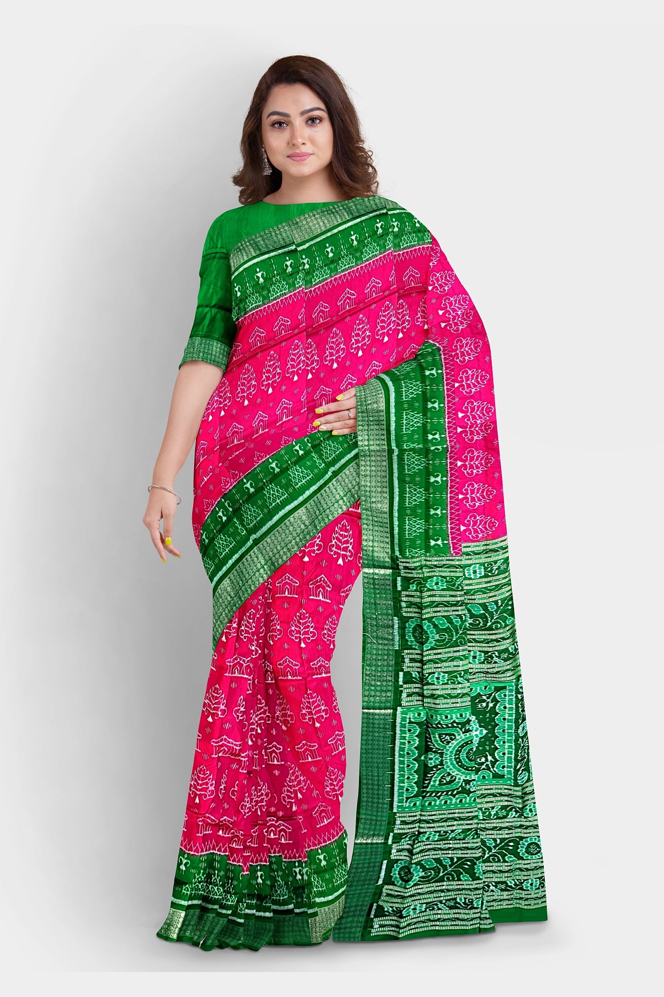 A stunning pink and green pure pata saree featuring tree and house motifs, a terracotta-inspired pallu with flowers, and intricate **muruja** designs.
