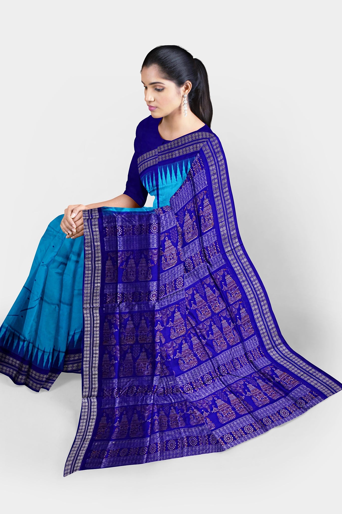 A beautiful sky and blue mix pata saree with plain body pattern and a temple design on the pallu.