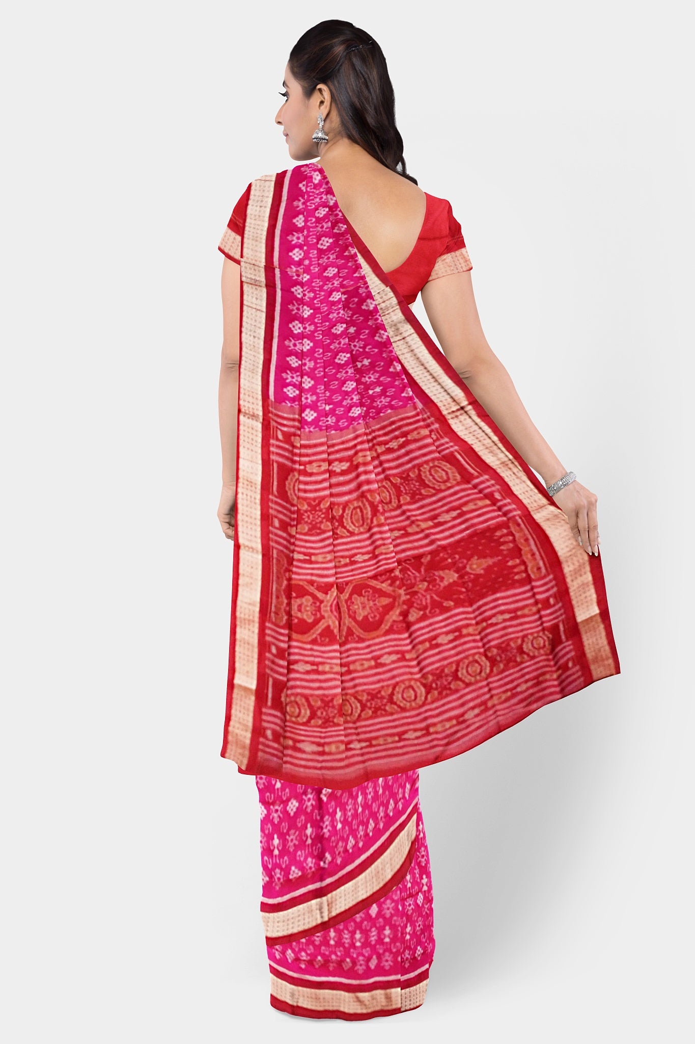 Pink and red Sambalpuri pata saree features a body with delicate little man and flower motifs, complemented by a Pasapali design. The pallu showcases intricate floral patterns.