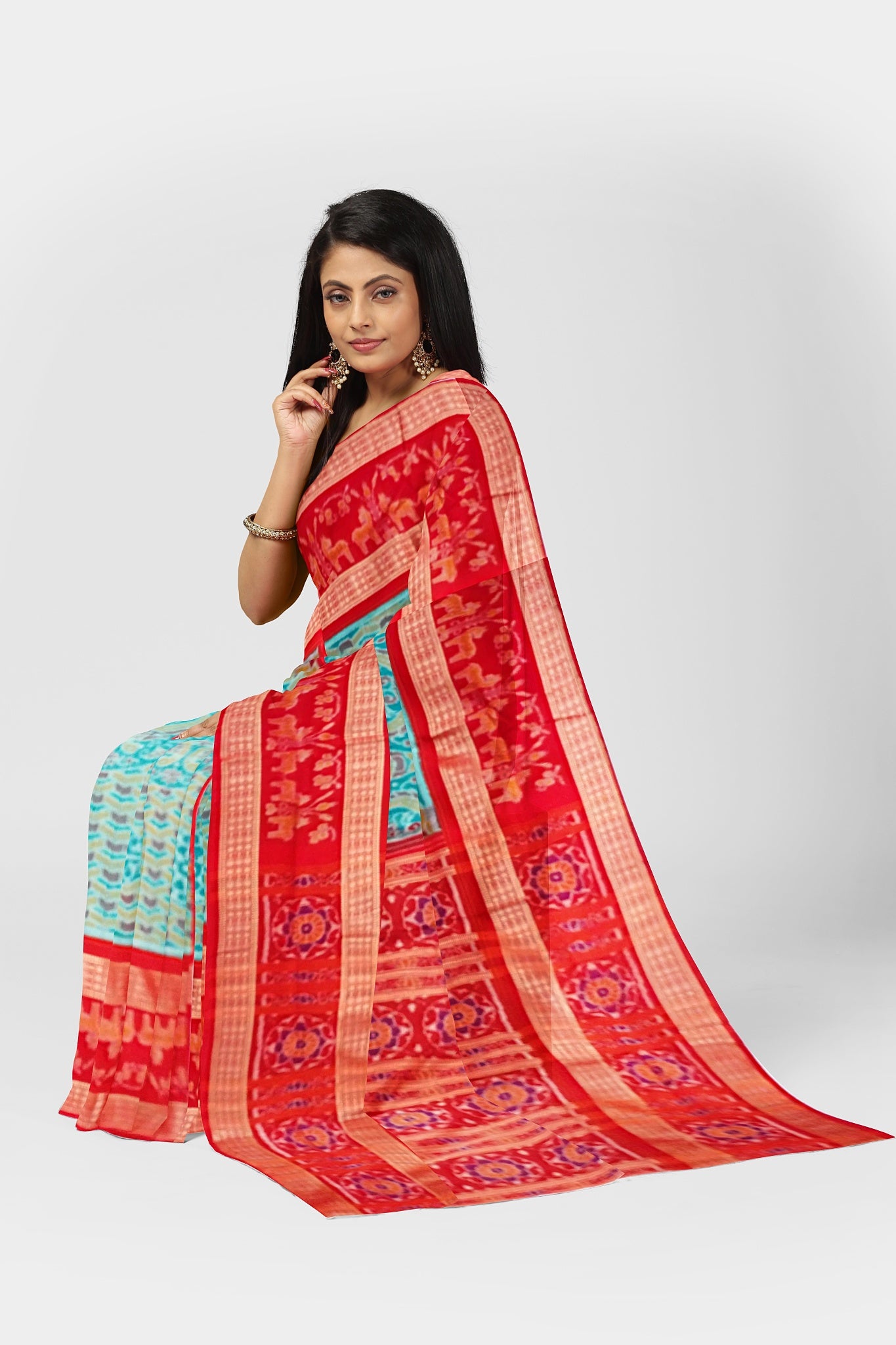 Sky blue and orange Sambalpuri cotton saree with a tree, deer, and peacock body pattern; the pallu features round floral designs.