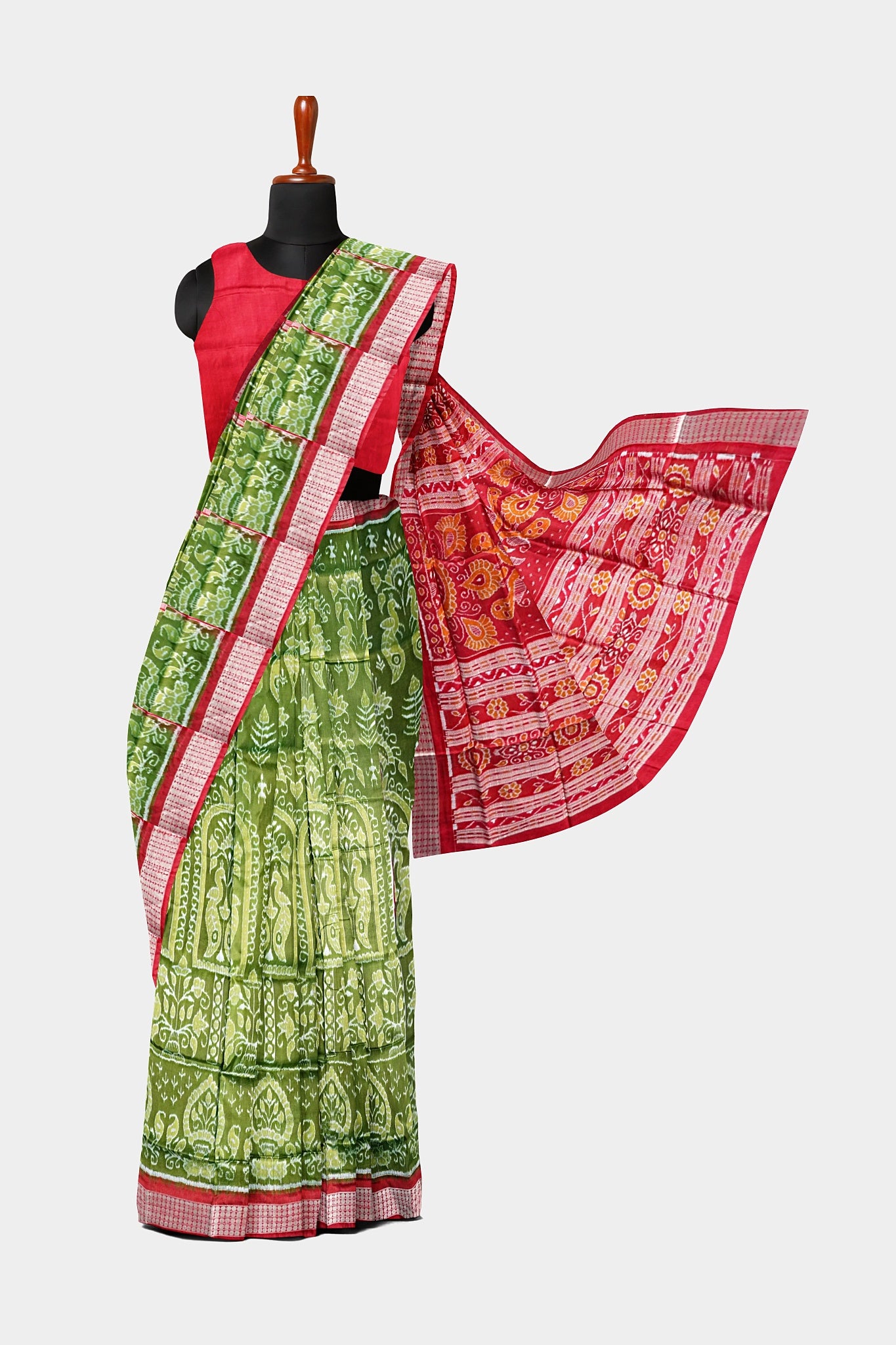 A deep green and red pure pata saree with nartaki and old design body pattern, and beautiful red flowers on the pallu.