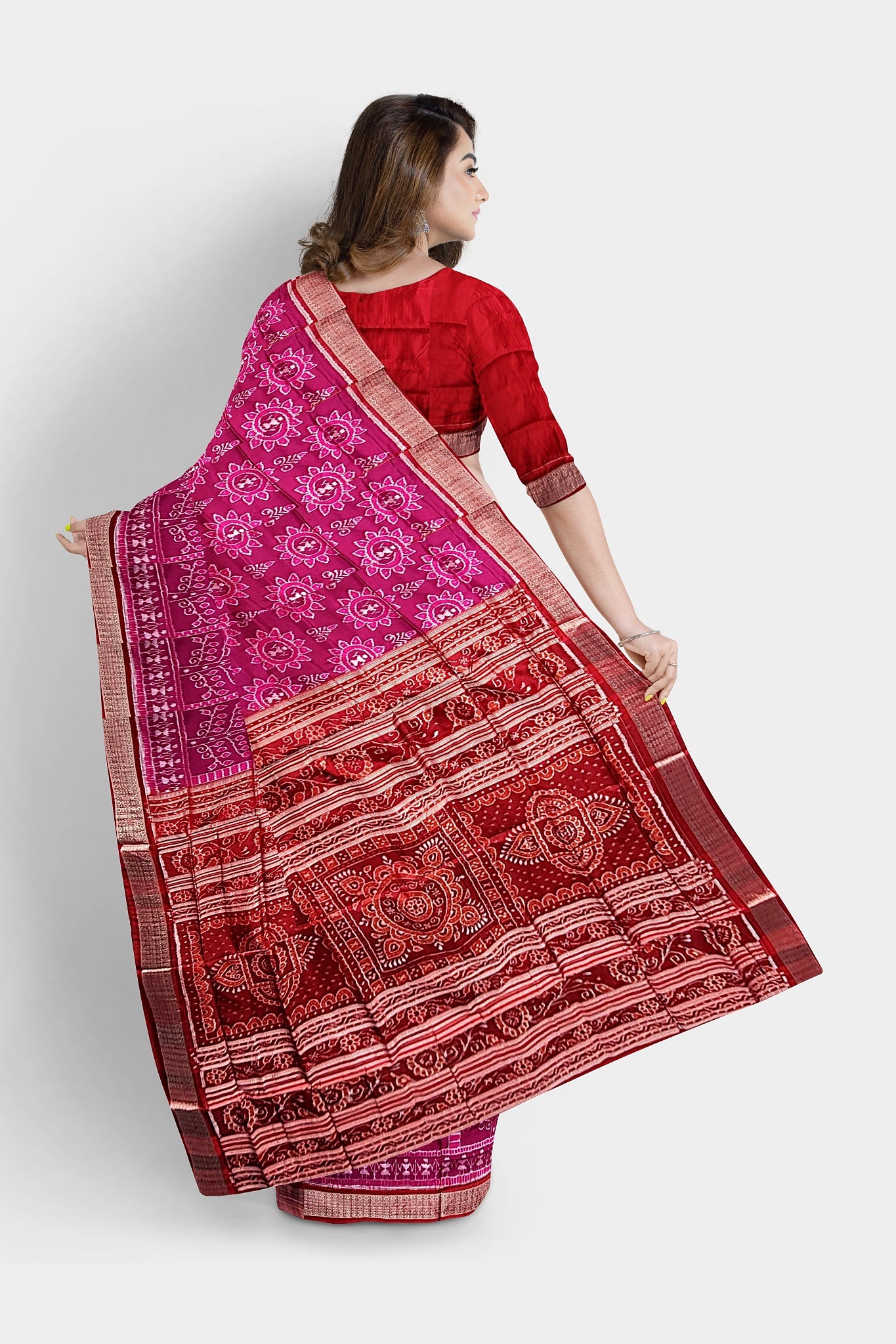 A pink and red saree featuring a terracotta tree design with floral motifs on the body, floral pallu, and dip-dyed border.