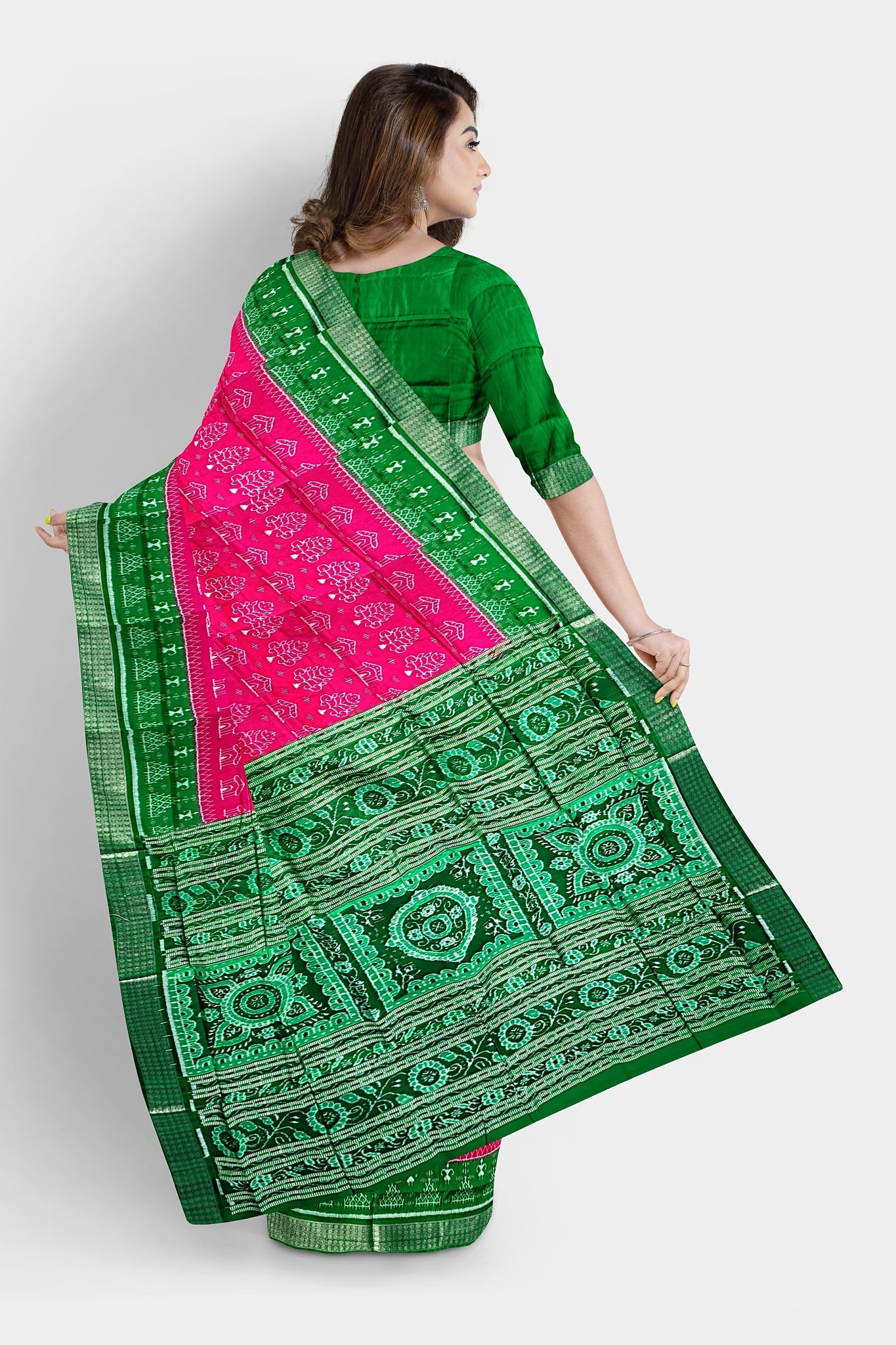 A stunning pink and green pure pata saree featuring tree and house motifs, a terracotta-inspired pallu with flowers, and intricate **muruja** designs.