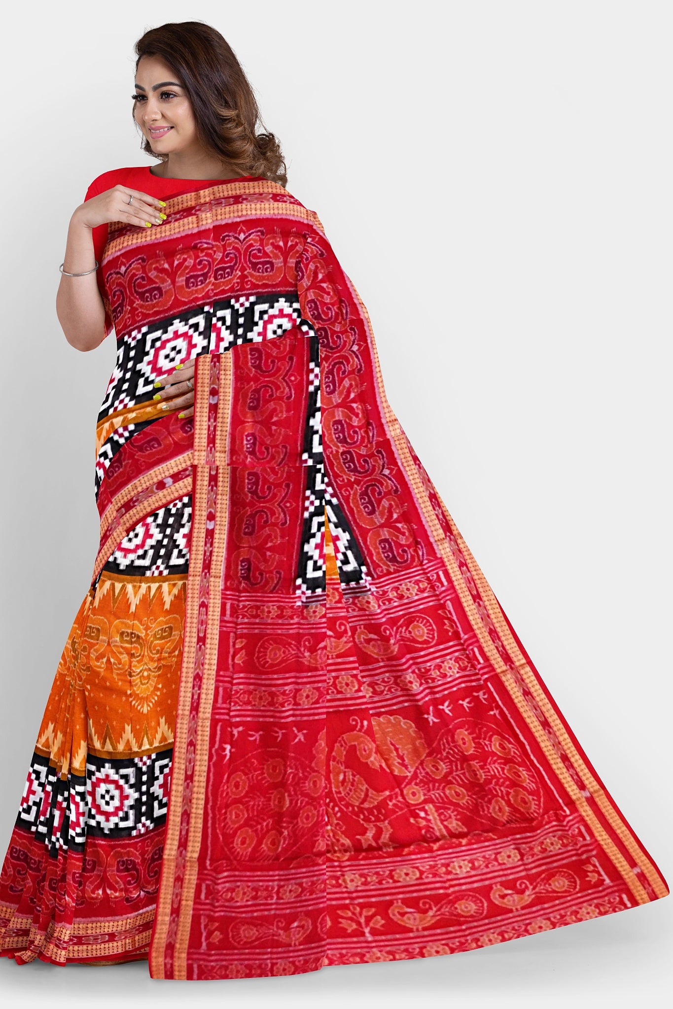 The red, black, and yellow Sambalpuri cotton saree features a duck motif, Pasapali chessboard-like border, and peacock design on the pallu.