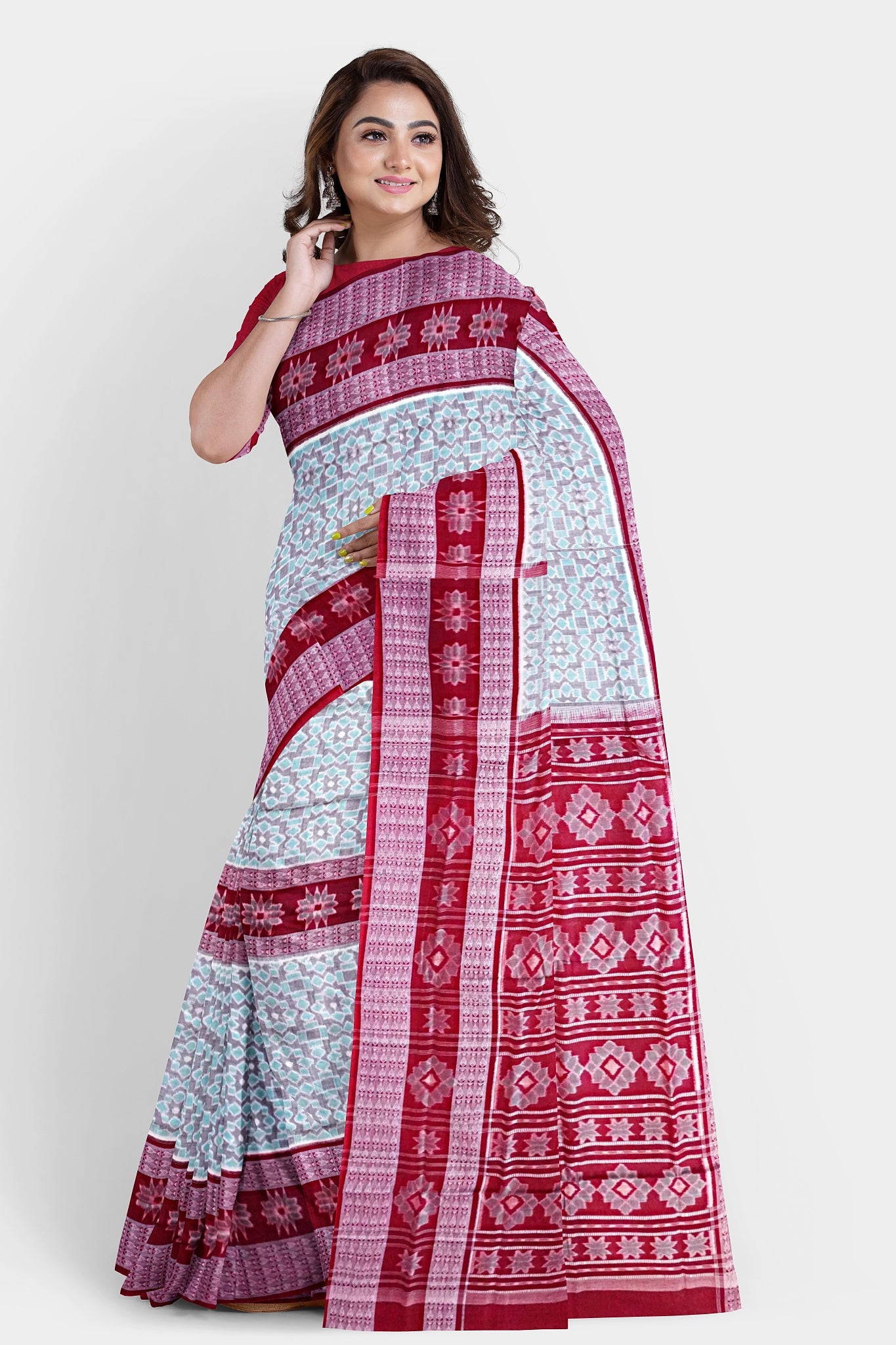 Cyan and maroon Sambalpuri cotton saree features round flower motifs on the body with a pallu adorned in intricate floral designs.