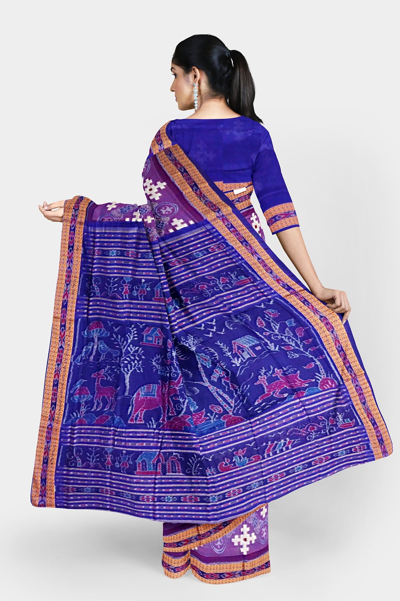 A Sambalpuri cotton saree with a purple and blue body featuring Nartaki, plus symbols, and a pallu design with elephants, trees, and birds.