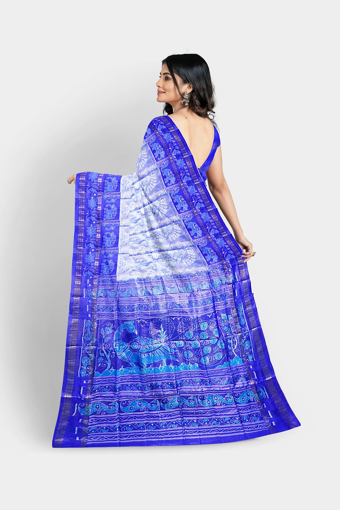 A blue and sky white pure pata saree with elephant and flower tree body pattern, and peacock-lata design on the pallu.