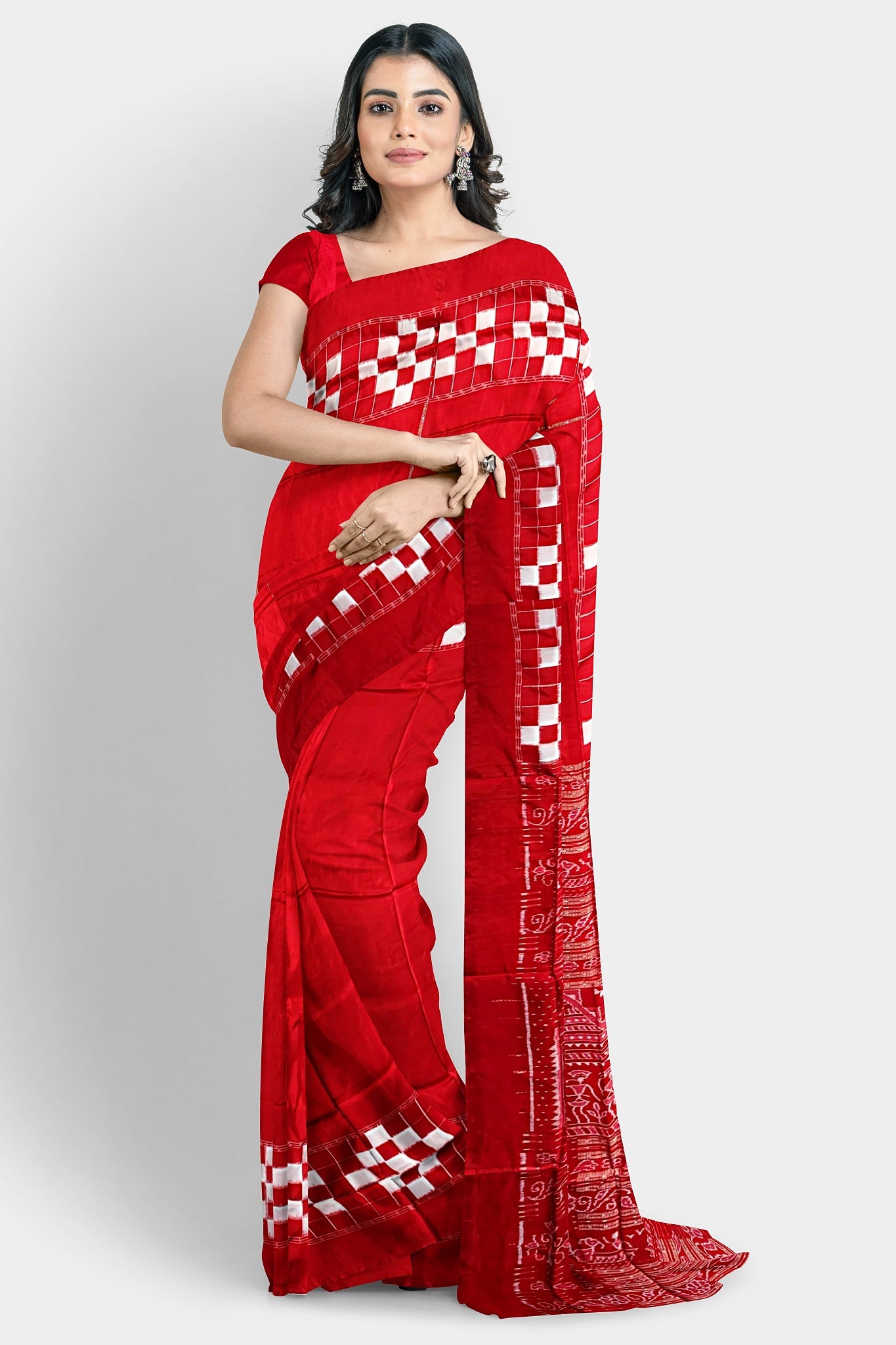 A red silk saree with a plain body, Passapli border, and a famous Boita design pallu featuring Adivasi patterns.