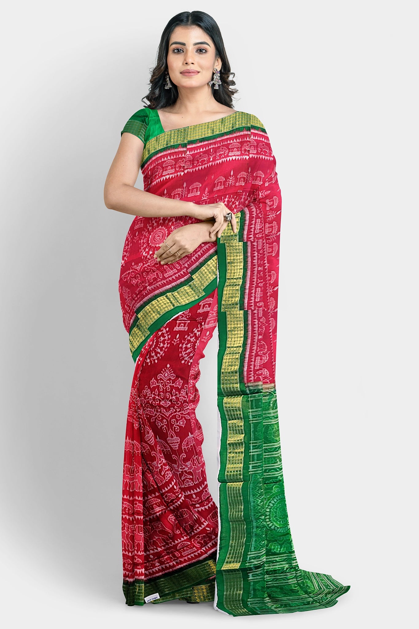 A pure Pata saree in red and green, featuring terracotta tree, elephant, and house motifs on the body, with floral and Sankha designs on the pallu.