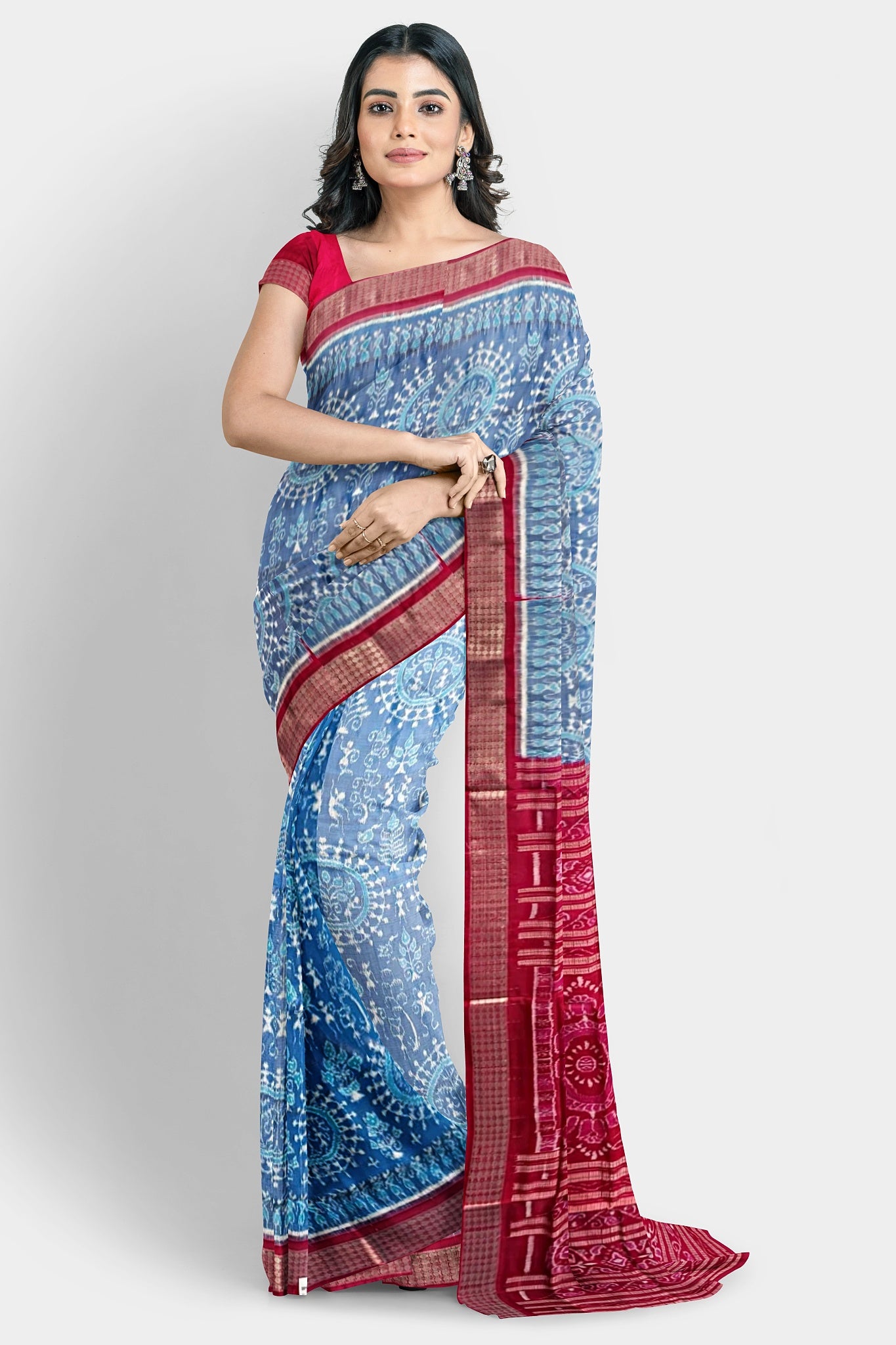 A sky blue and red shining pure Pata saree with terracotta small trees, big flowers, and pallu design featuring fish, vine, and bird.