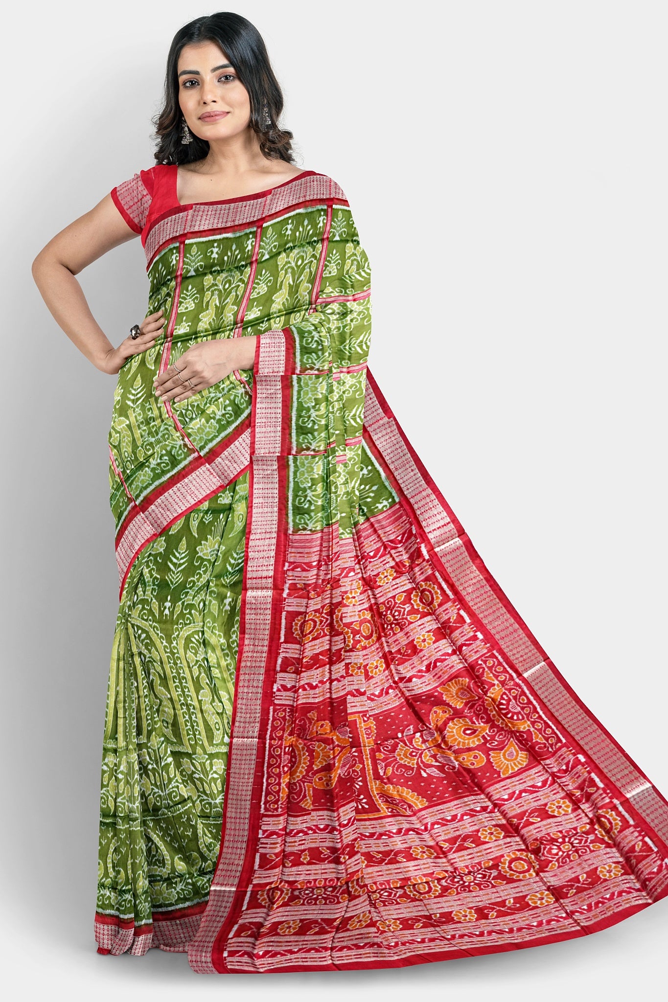 A deep green and red pure pata saree with nartaki and old design body pattern, and beautiful red flowers on the pallu.