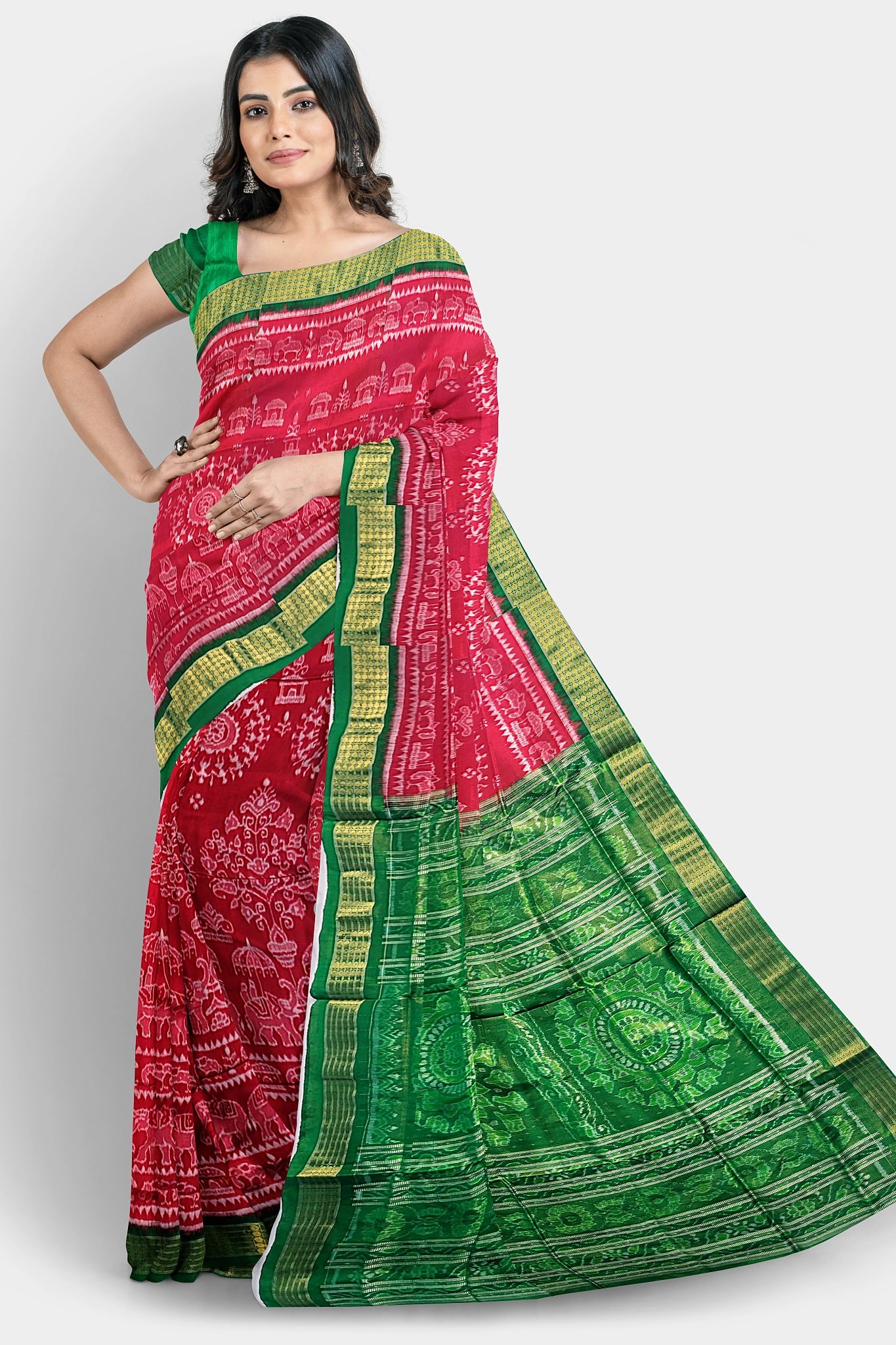 A pure Pata saree in red and green, featuring terracotta tree, elephant, and house motifs on the body, with floral and Sankha designs on the pallu.