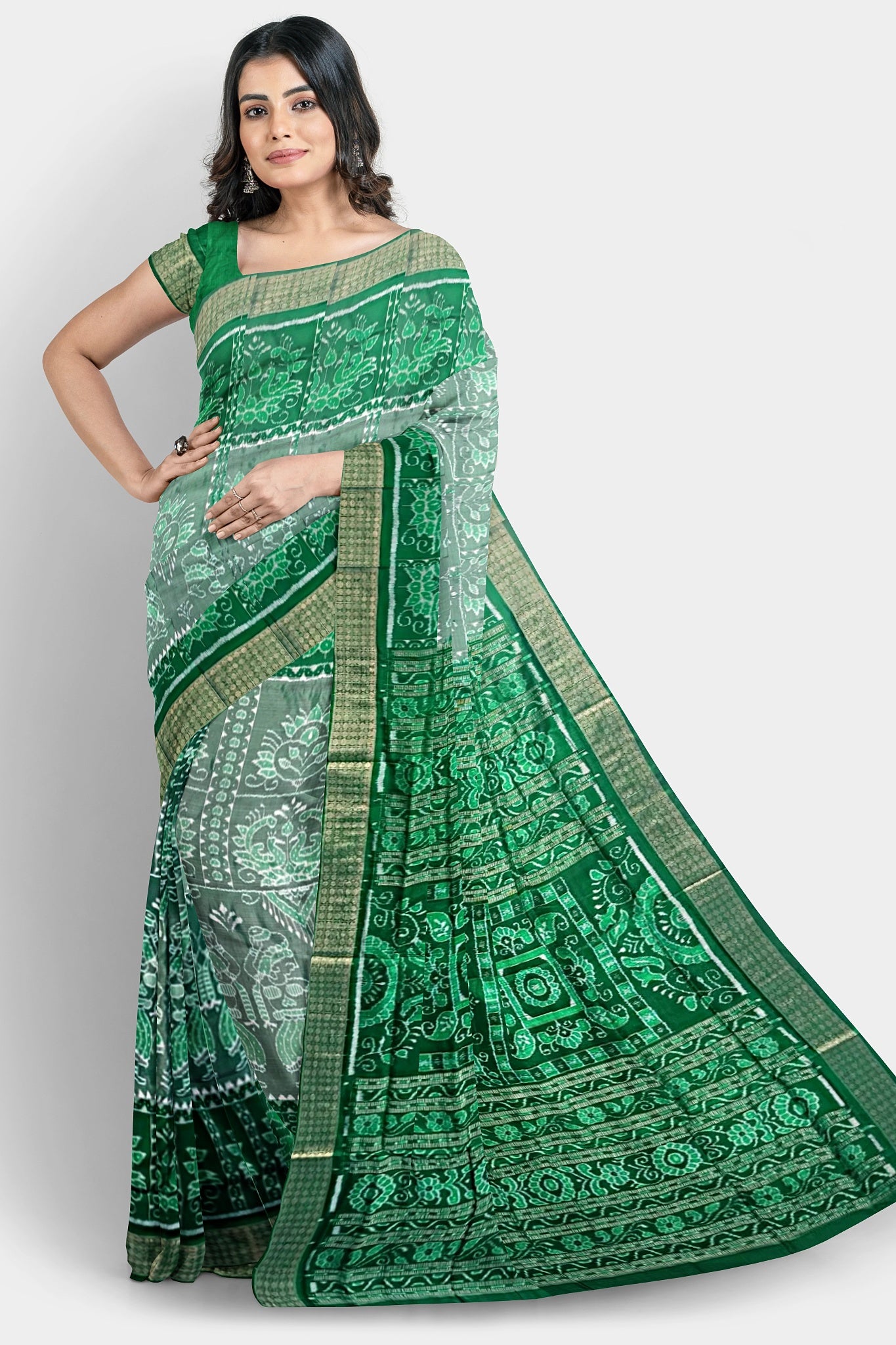 A white, deep green, and dark green pure shining Pata saree with Nartaki, peacock, and flower body pattern, and dark green pallu featuring three big flowers and vines.