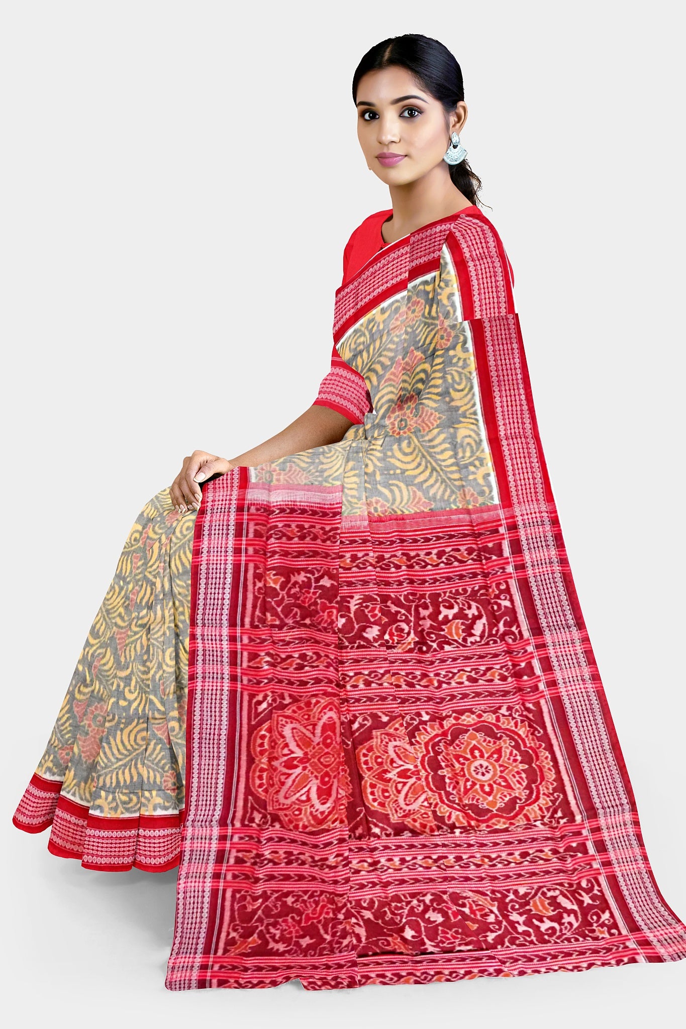 Yellow-red Sambalpuri cotton saree with a body adorned in many floral patterns and a pallu featuring a bold, big flower design.