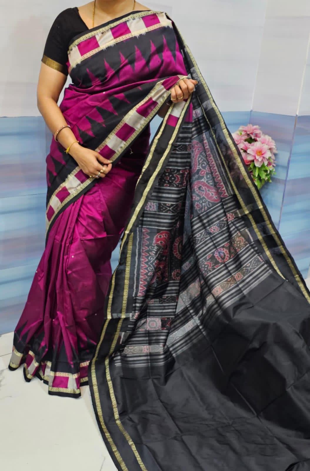 Pink and black Sambalpuri pata saree with plain body, box pattern border, kumbha pattern, and bandha work pallu.