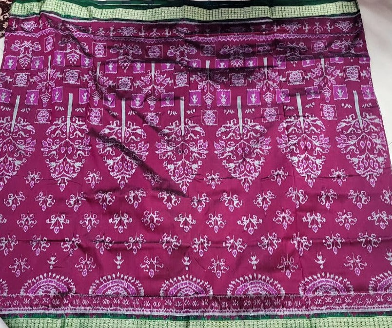 This purple and green saree features a beautiful tree design on the body and an exclusive pallu design in polyester-silk blend.