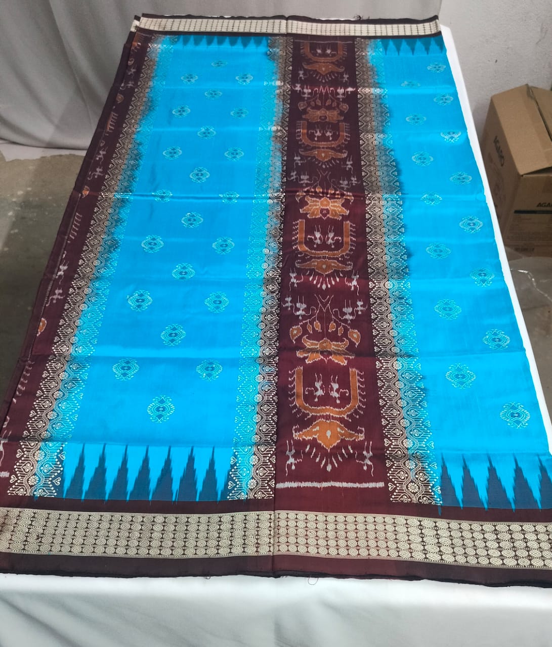 Rich maroon body with golden-beige motifs and borders