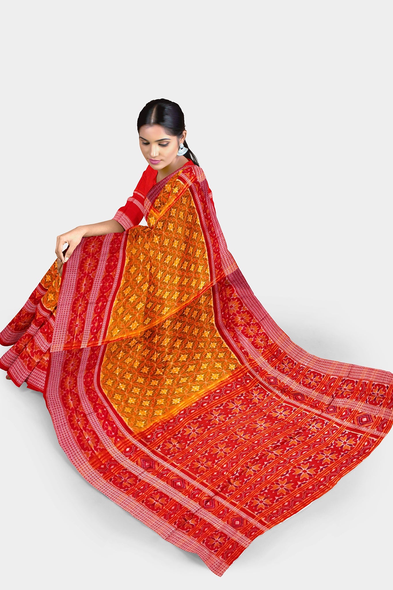 Yellow-red Sambalpuri cotton saree with a body covered in many floral patterns and a pallu featuring a large flower design.