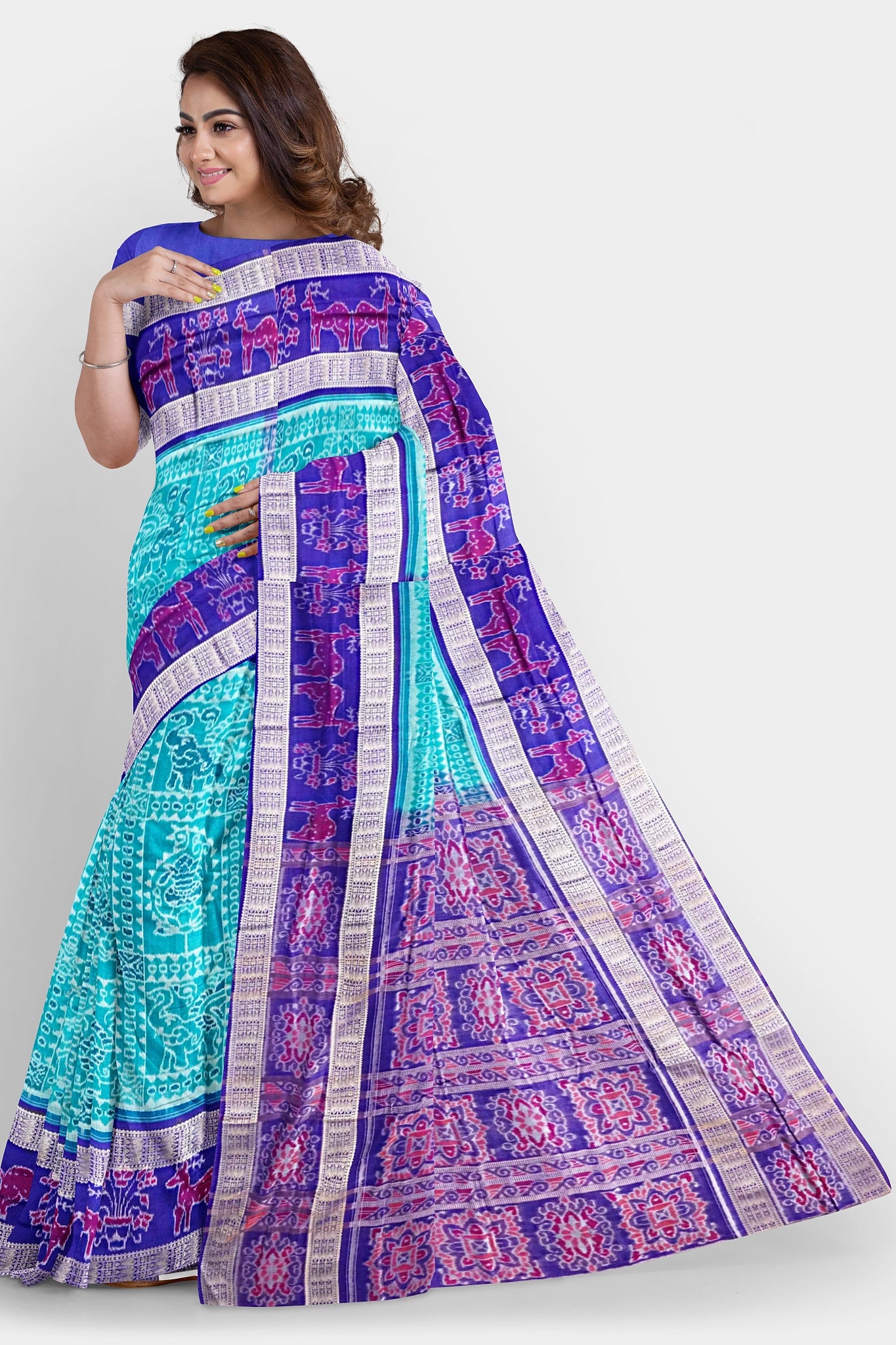 The blue and sky-colored Sambalpuri saree features intricate ikat patterns on the body, with a pallu adorned with beautiful flower designs.