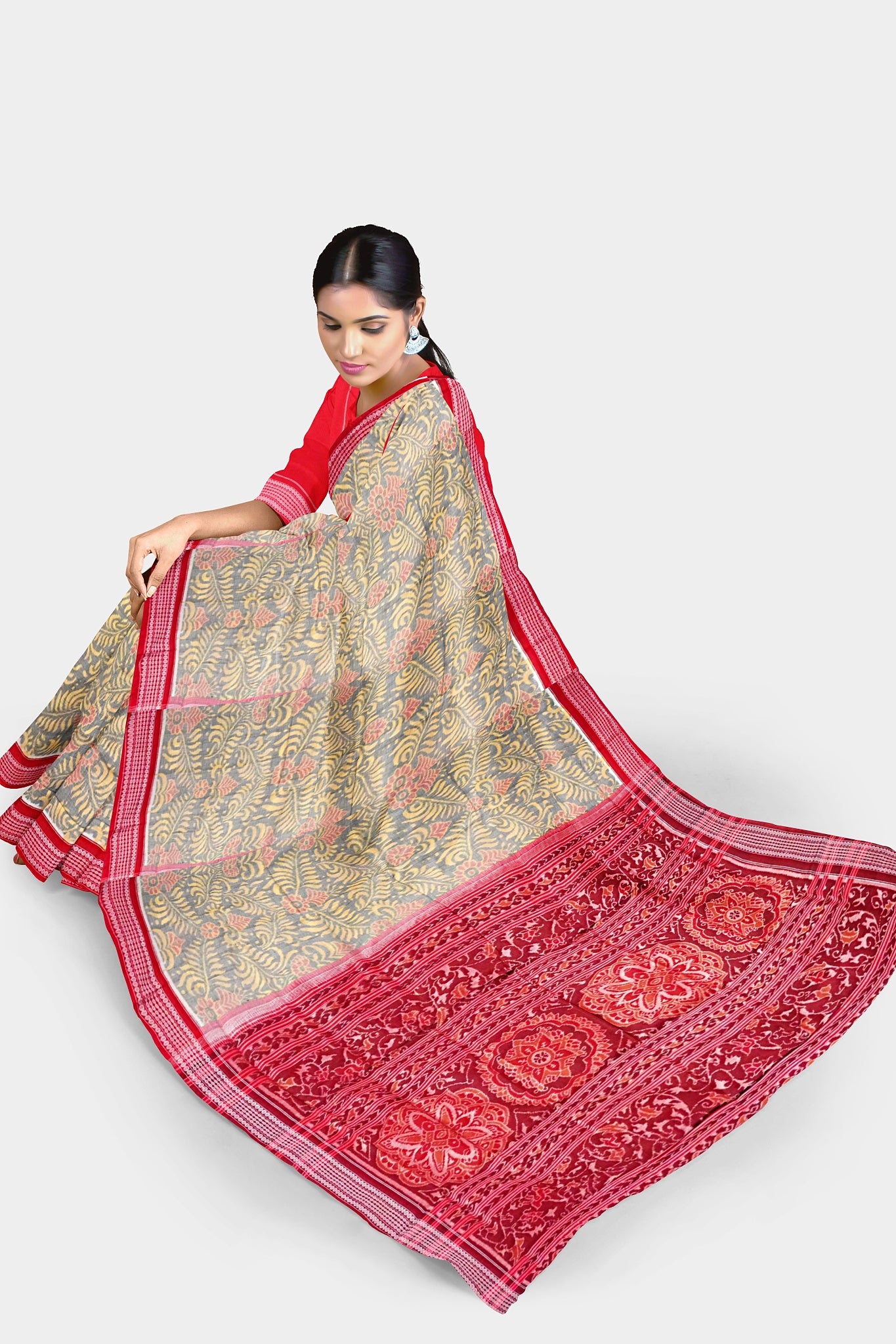 Yellow-red Sambalpuri cotton saree with a body adorned in many floral patterns and a pallu featuring a bold, big flower design.
