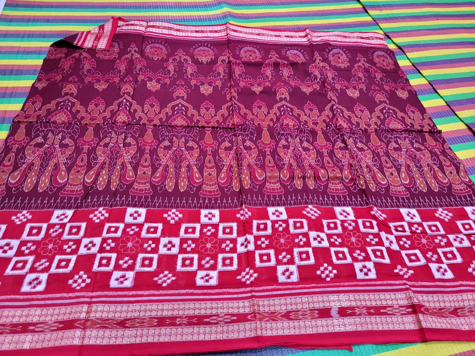 Coffee and Red pure Sambalpuri cotton saree features peacock with pasapali pattern, with a pallu design of peacock with fish. - Koshali Arts & Crafts Enterprise