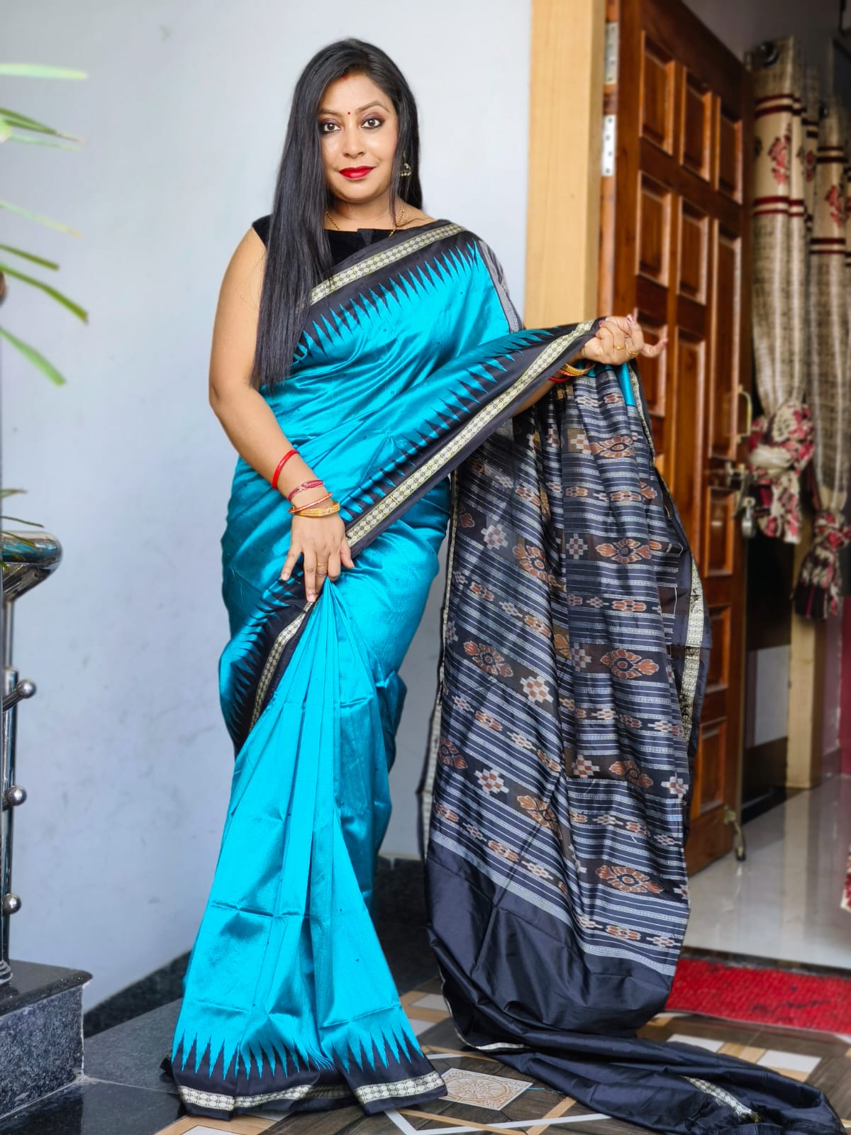 Pallu flowers pattern plain pata saree is Sky-blue and black color base. - Koshali Arts & Crafts Enterprise
